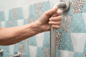 Vertical grab bar near the edge of a bathtub